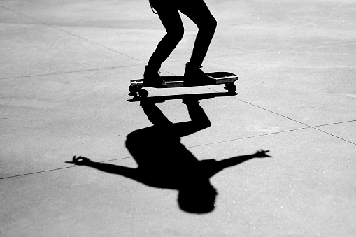 Unrecognizable man riding a skateboard.