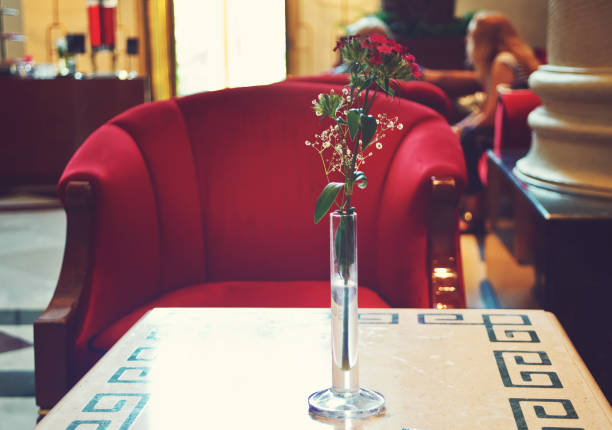 Hotel lobby lounge interior with red armchair and small table.