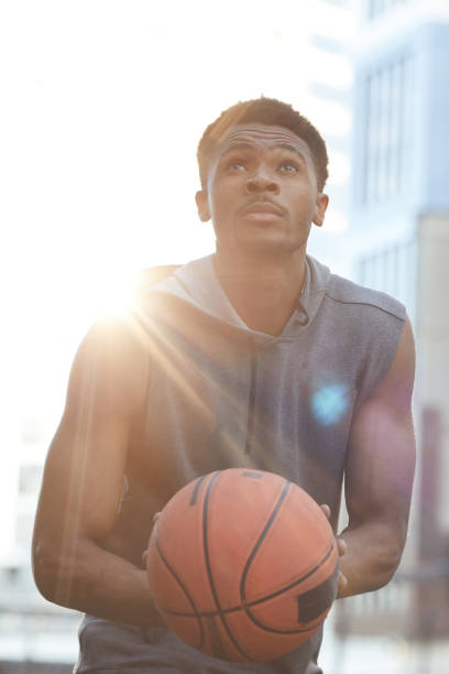 istock Handsome African-American Man Throwing Ball 1167585632