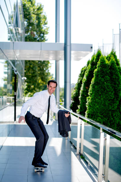 istock Stylish manager riding a skateboard 1167586581