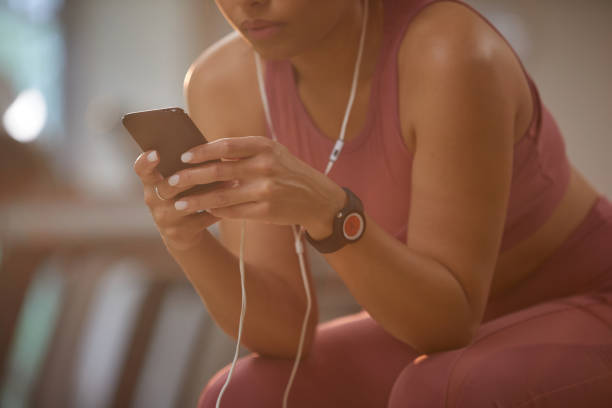 istock Woman Using Smartphone in Gym Closeup 1167586775