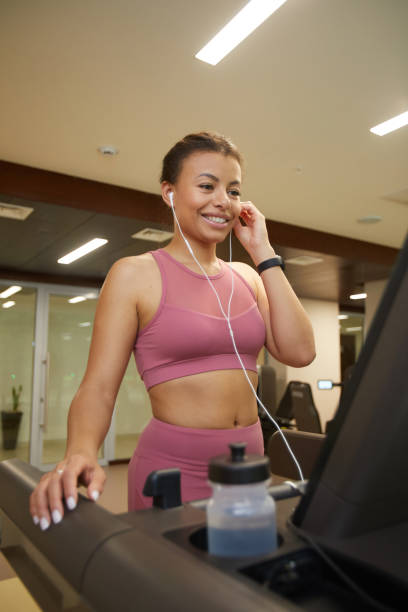 istock Smiling Woman Running on Treadmill 1167586932