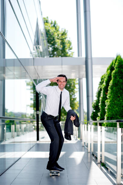 istock Stylish manager riding a skateboard 1167587025