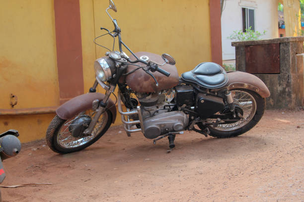 istock Old rusty motorbike above orange wall 1167587271
