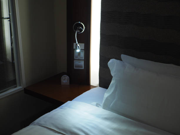 istock Bedside lamp in hotel room at night 1167588097