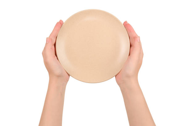 istock Empty plate in woman hands isolated on white background. 1167588468
