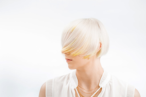 Portrait of Fashionable Young Woman With Bleached Hair Covering Her Face.