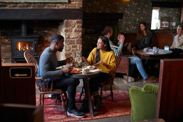 istock Couple At Table In Traditional English Pub Eating Breakfast 1167590425