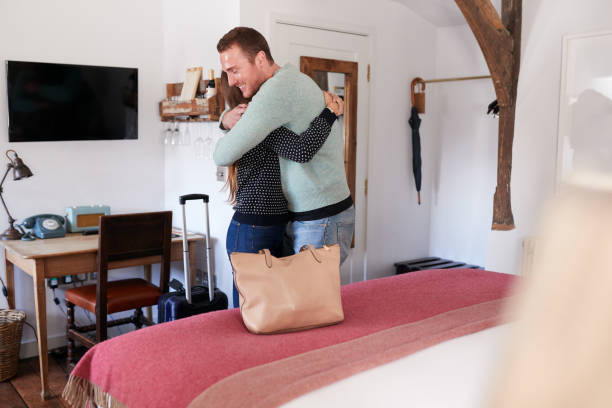 istock Couple Spending Romantic Weekend Away Hugging In Hotel Room 1167591845