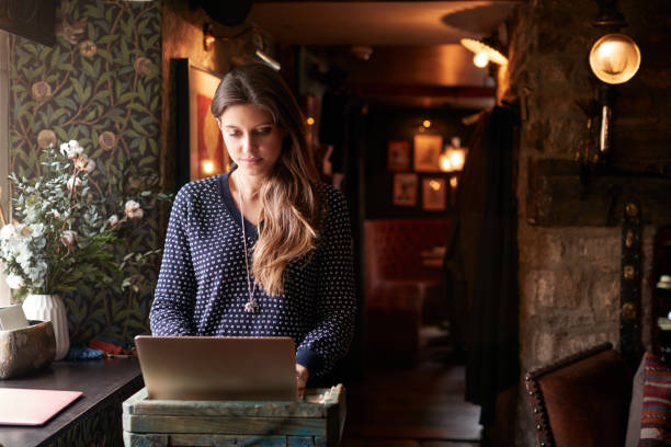 istock Female Receptionist Working On Laptop At Hotel Check In 1167591895