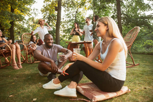 istock Happy friends eating and drinking beers at barbecue dinner on sunset time 1167592087