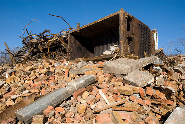 An old boiler sits atop the pile of rubble in a Detroit Building Demolition.