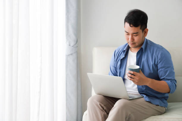 istock Asian man in living room 1167593015