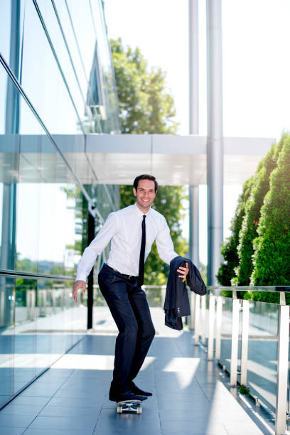 istock Stylish manager riding a skateboard 1167593284