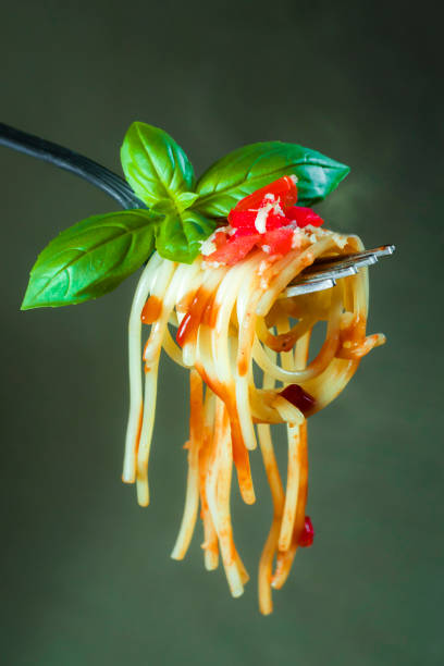 istock Fresh spaghetti on a fork photographed close up 1167593368
