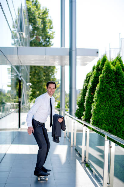 istock Handsome businessman riding skateboard 1167593493