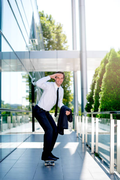 istock Young happy entrepreneur riding a skateboard 1167594362