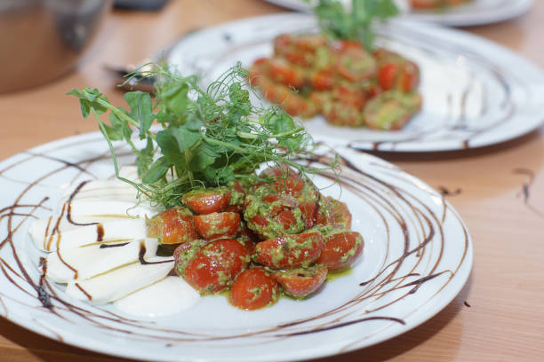 istock On the table is a freshly prepared caprese salad with pesto and cherry tomatoes for several people 1167594815