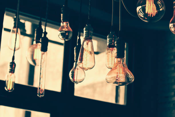 istock Vintage light bulb with the window in the background 1167595201