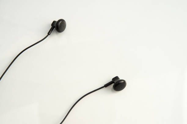 istock small black headphones on white background close-up 1167597127