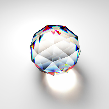 Glass prism icosphere with refracting colorful light on white background