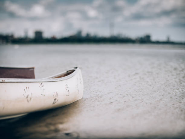 City panorama of downtown Toronto, view off the Lake Ontario. Wooden canoes pared on the shore in the foreground. Selective focus achieved with tilt and shift lens, applying maximum amount of tilt.