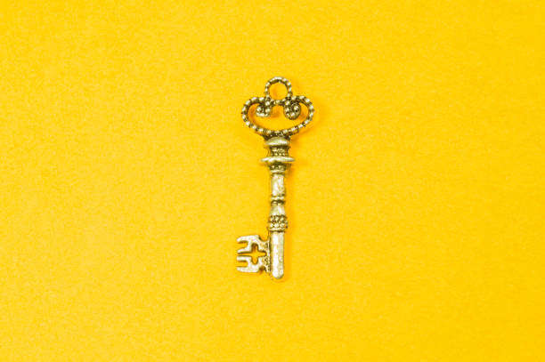istock Vintage key isolated on yellow background 1167598766