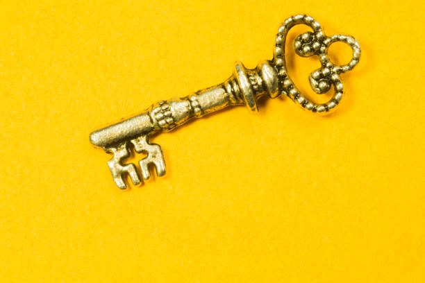 istock Vintage key isolated on yellow background 1167599025