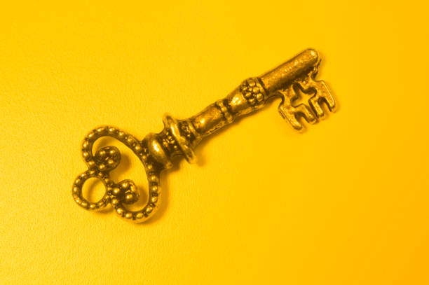 istock Vintage key isolated on yellow background 1167599037