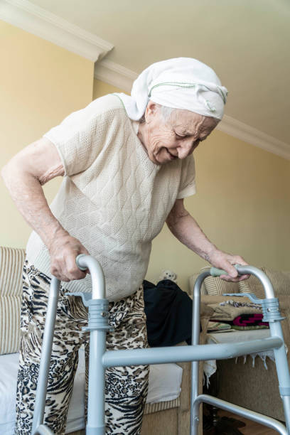 istock A senior woman standing with a walker in home 1167604499