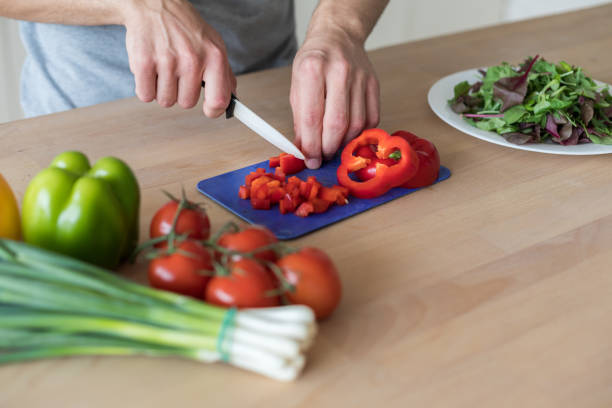 Man preparing healthy vegetables salad