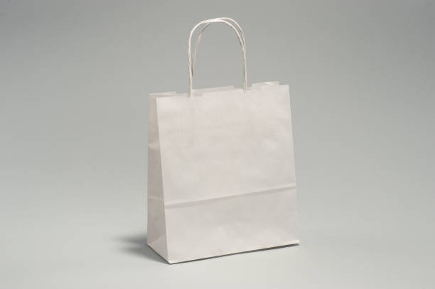 istock White paper bag with handles for shopping, in the studio 1167618442