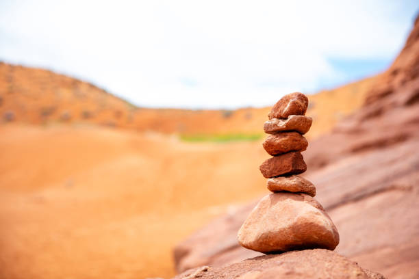 Harmony, balance in nature. Zen stones stack, blur red desert background. Antelope canyon Arizona, US.