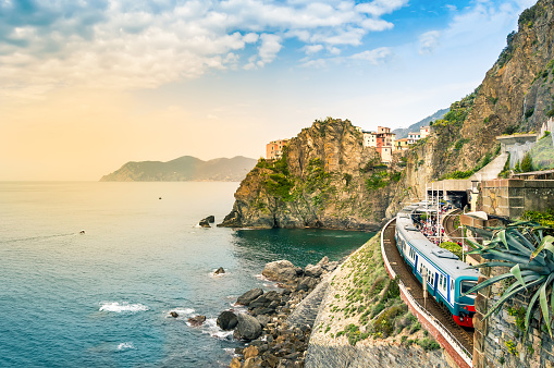 Manarola, Cinque Terre - train station in small village with colorful houses on cliff overlooking sea. Cinque Terre National Park with rugged coastline is famous tourist destination in Liguria, Italy