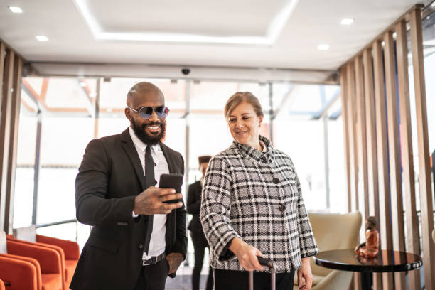 istock Coworking laughing together and using cellphone inside an airport VIP lounge 1167623446