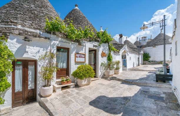Scenic sight in Alberobello, the famous Trulli village in Apulia, southern Italy. May-28-2017 Scenic sight in Alberobello, the famous Trulli village in Apulia, southern Italy. May-28-2017 alberobello photos stock pictures, royalty-free photos & images