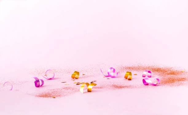 istock Confetti on pink background with golden sparkles. Concept for festive background or for project 1167625621
