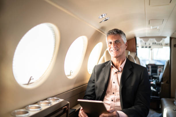 istock Portrait of a businessman using digital tablet in a private jet 1167625887