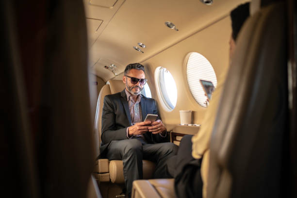 istock Businessman working and using smartphone in a corporate jet 1167625891