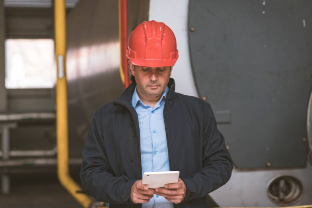 istock Engineer is Controlling the Work of Heating Plant on his Tablet 1167625961