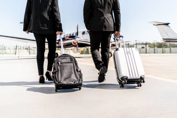 istock Low section of two people walking in airplane runway, rear view 1167626083