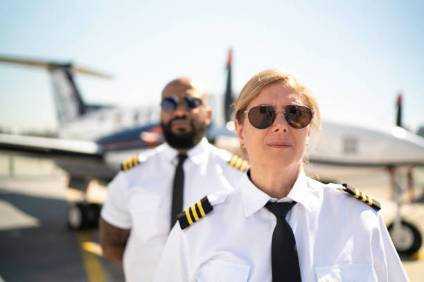 istock Two airplane pilots in a hangar and looking at camera 1167626937