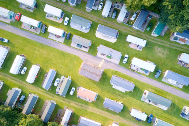 Caravan site park aerial view illuminated by summer sun Caravan site park aerial view illuminated by summer sun uk camper trailer stock pictures, royalty-free photos & images