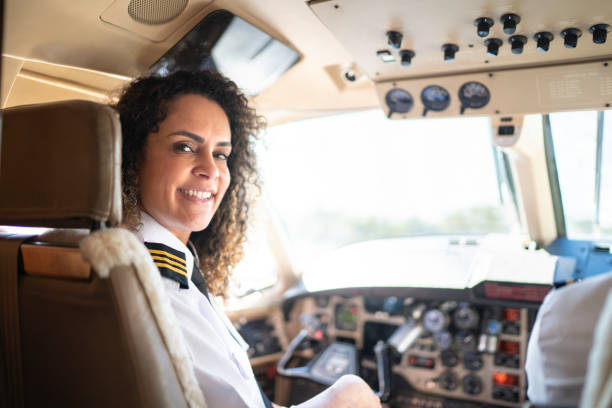 istock Portrait of airplane pilot looking over shoulder in a private jet 1167627043