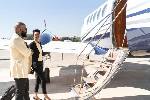 Colleagues boarding into flight in a corporate jet Colleagues boarding into flight in a corporate jet rich black men pictures stock pictures, royalty-free photos & images