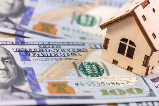 istock wooden symbol house with dollars banknotes 1167627135