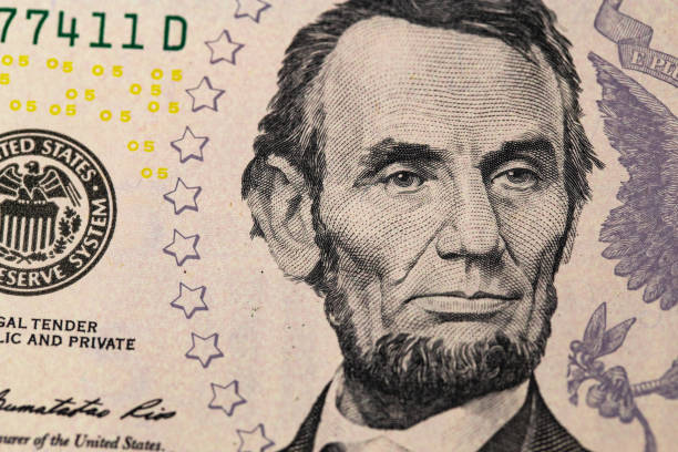 istock Abraham Linkoln portrait. Five dollars banknote closeup macro. 1167627334