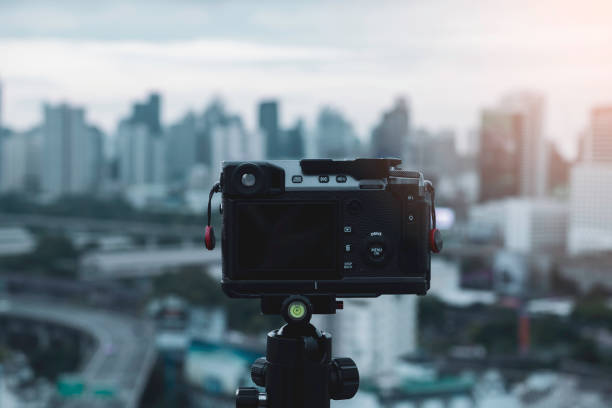 istock Digital camera on tripod with city view on background 1167628211
