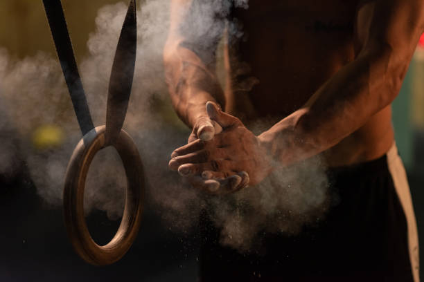 Getting ready for weightlifting Close up of male athlete putting gym chalk on hands crossfit chalk weightlifting weight training stock pictures, royalty-free photos & images