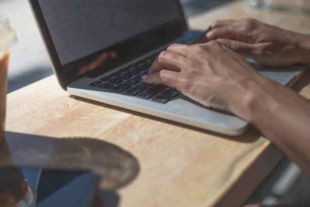 istock Young woman using laptop in a cafe. 1167628549